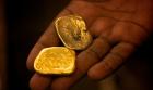 Gold pieces in a miner's hand in Congo.