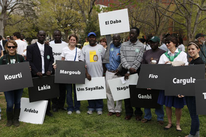 Activists hold up the names of villages destroyed in Darfur